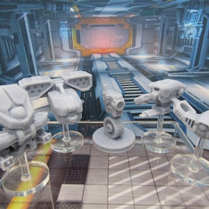 May include: Four grey plastic miniature robots on clear plastic bases. The robots are in various poses and have different designs. The robots are on a grey and white tiled surface.