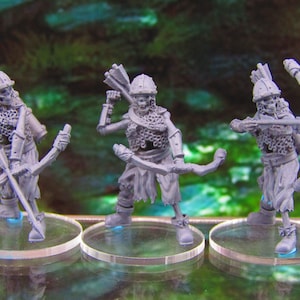 May include: Three gray plastic skeletal figures of archers, each with a bow and arrow, standing on clear plastic bases.