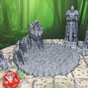 May include: A set of five gray 3D printed miniature statues of knights in armor, standing on a gray stone base. The statues are broken and weathered, with swords held in their hands. The base is a circular platform with a textured surface.