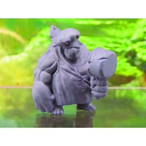 May include: A grey, 3D printed miniature figure of a creature with a large hammer. The creature has a large head with a helmet and a muscular body.