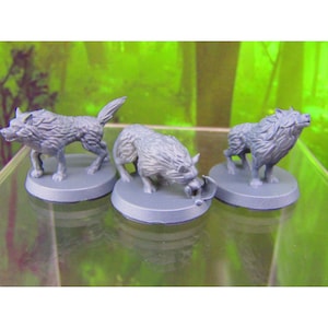 May include: Three gray painted miniature wolf figurines on round bases. The wolves are in different poses, one is standing, one is walking, and one is eating.