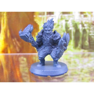 May include: A blue plastic miniature figurine of a dwarf warrior holding a sword and shield. The dwarf has a beard and a fiery mane of hair.