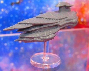 May include: A gray plastic spaceship model with a detailed design, mounted on a clear plastic base.