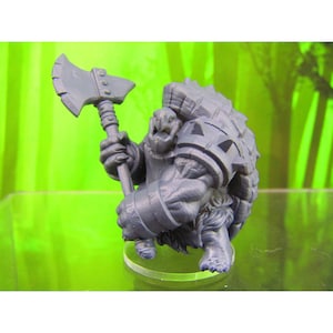 May include: A grey plastic miniature figurine of a turtle-like creature holding an axe. The creature has a shell with spikes and is wearing armour. The figurine is on a clear plastic base.