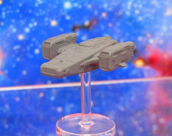 May include: A gray spaceship model with a detailed design, featuring multiple engine pods and a sleek, futuristic shape. The model is mounted on a clear plastic stand.