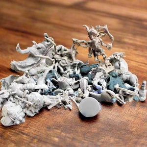 May include: A collection of unpainted miniature figurines, including a dragon, a spider, and a demon, all made of gray plastic.