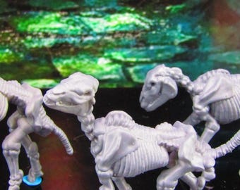 May include: Four white skeletal horse figurines, posed in different positions, with a green and blue background.