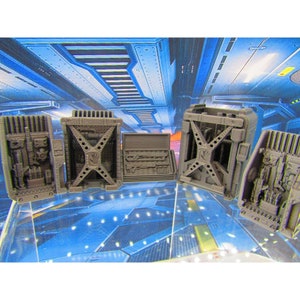 May include: Five grey 3D printed plastic wall panels with different designs. The panels have a futuristic, sci-fi aesthetic.
