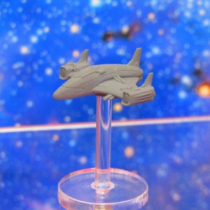 May include: A gray plastic model of a spaceship with a pointed nose and two engines on the back. The model is mounted on a clear plastic stand.