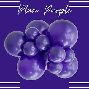 May include: A cluster of purple balloons arranged in a bunch. The balloons are a deep, rich purple color, similar to the color of plums.