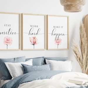 May include: Three framed prints with motivational quotes and watercolor pink flowers. The quotes are "Stay positive", "Work hard", and "Make it happen".