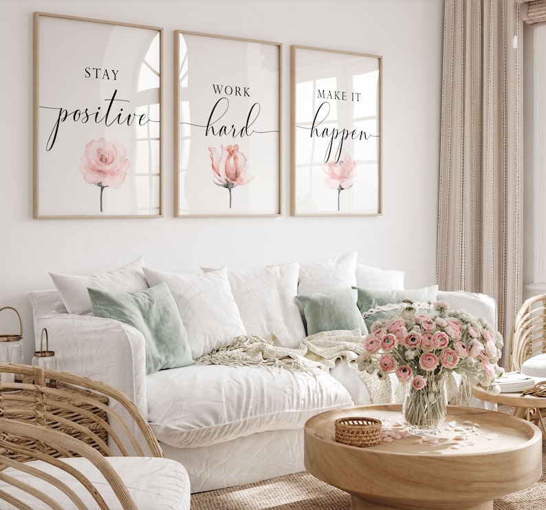 May include: Three framed prints with motivational quotes and watercolor pink flowers. The quotes are "Stay positive", "Work hard", and "Make it happen".