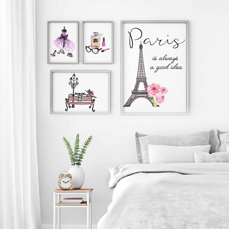 May include: Three framed prints with a Parisian theme. The first print features a purple dress with black accents, the second print features a perfume bottle, glasses, and nail polish, and the third print features the Eiffel Tower with the text "Paris is always a good idea".