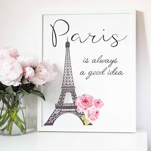 May include: A white framed print with a black silhouette of the Eiffel Tower and the text "Paris is always a good idea". Pink watercolor roses are on the right side of the image.