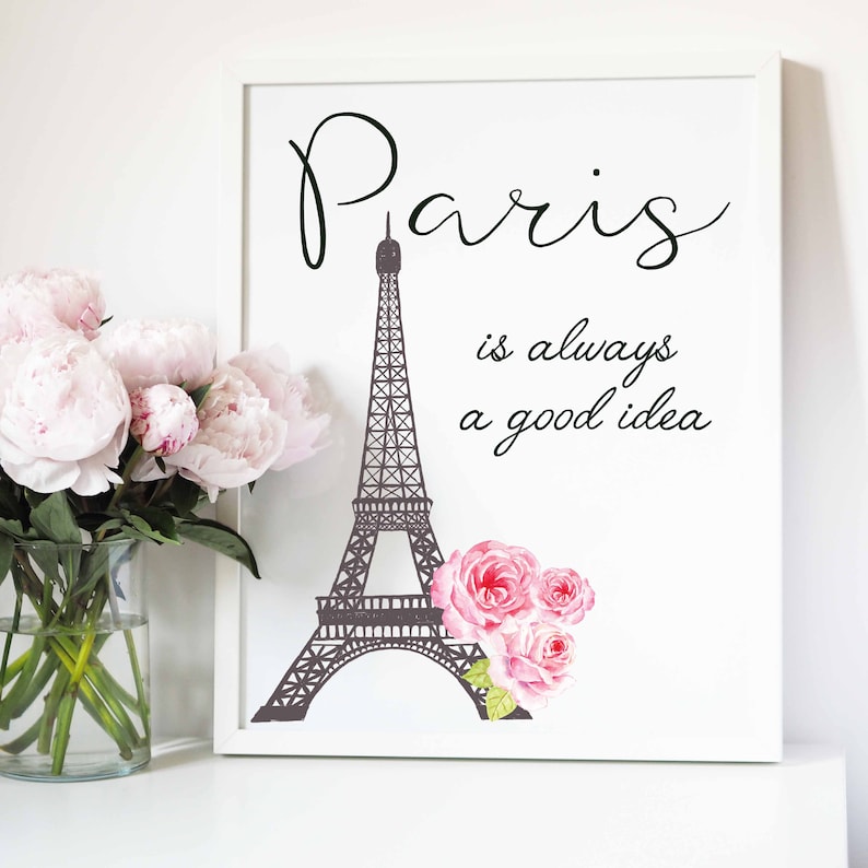 May include: A white framed print with a black silhouette of the Eiffel Tower and the text "Paris is always a good idea". Pink watercolor roses are on the right side of the image.