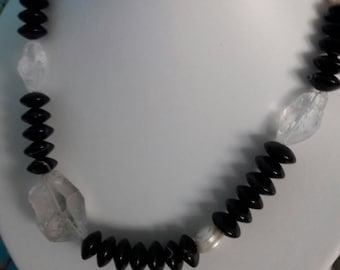 Collier with exciting contrasts, polished Onyx, raw Mountain crystal and noble freshwater pearl