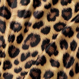 May include: A fabric featuring a repeating leopard print pattern with a golden tan base colour and dark brown to black spots. The material displays soft folds and creases, creating a textured appearance with a smooth, slightly reflective surface finish.