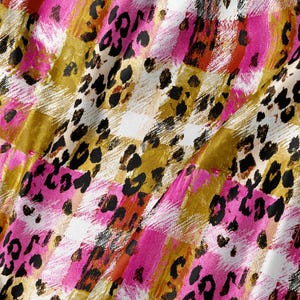 May include: A fabric featuring a patchwork design of squares in vibrant pink, mustard yellow, and white. The pattern is overlaid with a black leopard print consisting of irregular spots and markings, creating a textured and multi-layered visual effect.
