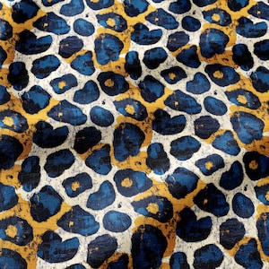 May include: A fabric featuring a repeating leopard print pattern with dark blue spots, mustard yellow centers, and a distressed white background. The design has a textured, painted appearance with irregular shapes and varying color intensity.