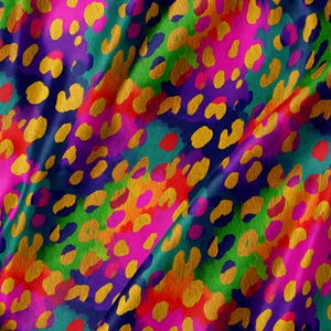 May include: A fabric featuring a vibrant, multicolored leopard print pattern. The design consists of overlapping splotches in bright shades of pink, green, orange, and purple, accented with repeating golden-yellow animal print spots.