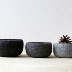 Three felt wool bowls in differents grey hues