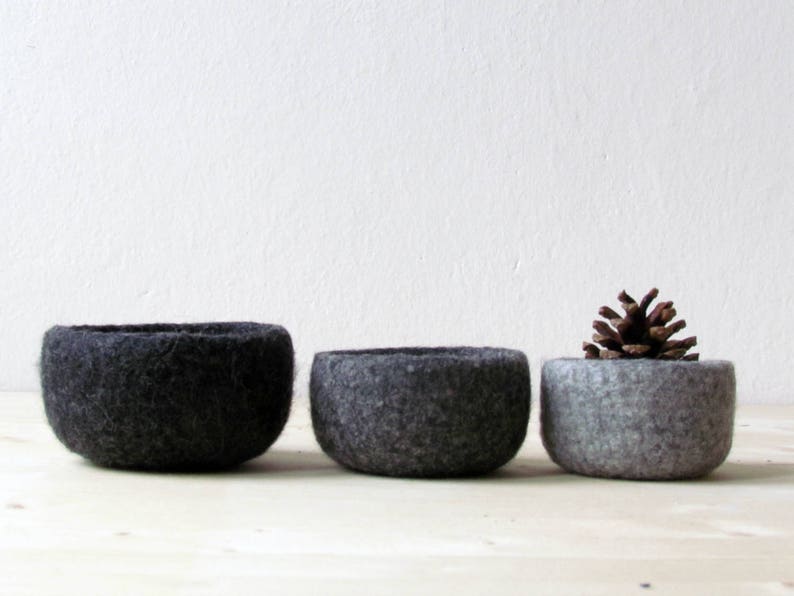 Three felt wool bowls in differents grey hues