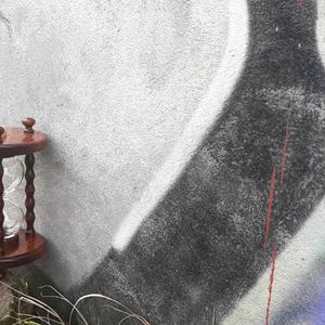 May include: A set of three ceramic mugs with a speckled, matte finish. The mugs are in shades of cream, light grey, and dark grey. Each mug has a simple, minimalist design, ideal for coffee or tea.