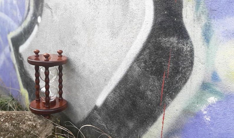 May include: A set of three ceramic mugs with a speckled, matte finish. The mugs are in shades of cream, light grey, and dark grey. Each mug has a simple, minimalist design, ideal for coffee or tea.