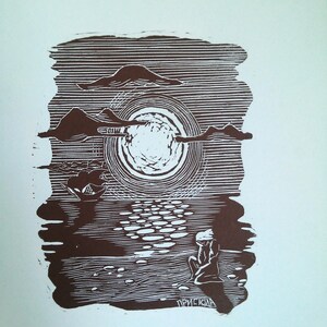 May include: A brown and white linocut print depicting a serene seascape. The artwork features a large sun, clouds, and a figure seated on the shore, with the artist's signature at the bottom. The scene is rendered with detailed lines.
