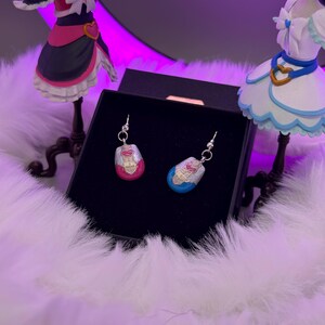 pretty cure magical phone pendant earrings made in metal with pink and blue details