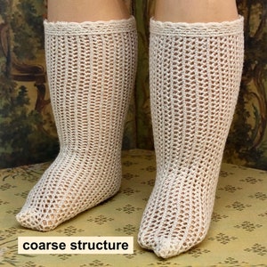 May include: A pair of white crocheted stockings with a coarse structure. The stockings have a scalloped edge at the top.