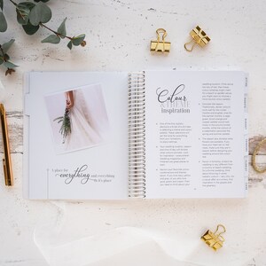 May include: An open notebook with a white background and gold spiral binding. The notebook has the words "Colour & Theme Inspiration" on the cover. The page is open to a section about choosing a wedding colour scheme. The text on the page includes tips for selecting colours based on the wedding location, season, and formality.
