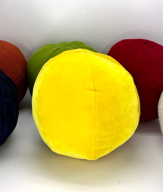 round yellow throw pillow