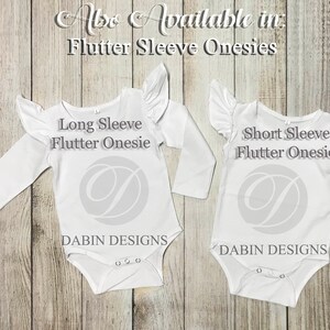 May include: Two white baby onesies with flutter sleeves. The onesie on the left has long sleeves and the onesie on the right has short sleeves. Both onesies have the text "Flutter Onesie" and "Dabbin Designs" printed on them.