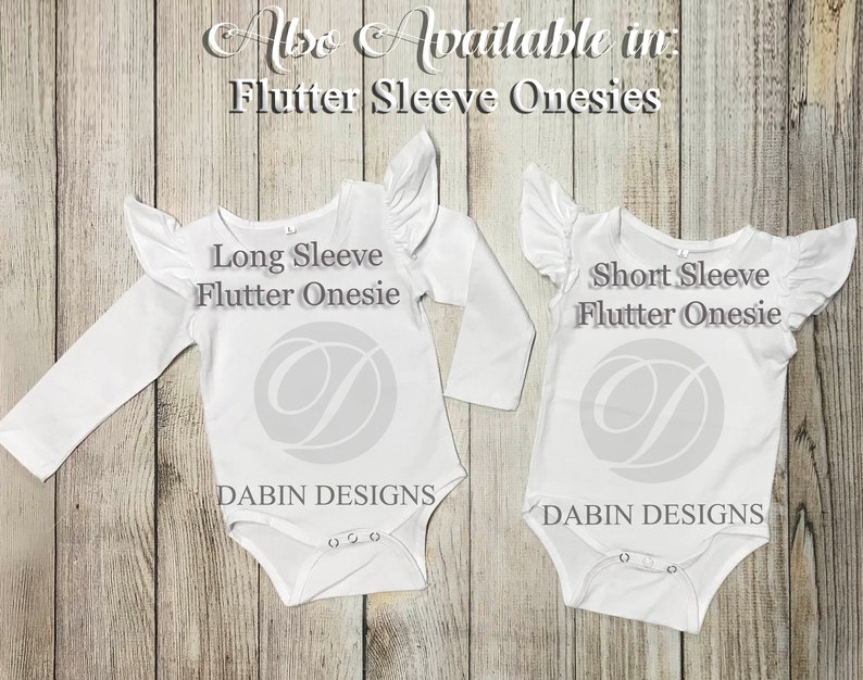 May include: Two white baby onesies with flutter sleeves. The onesie on the left has long sleeves and the onesie on the right has short sleeves. Both onesies have the text "Flutter Onesie" and "Dabbin Designs" printed on them.