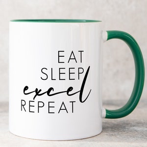 May include: A white ceramic mug with a dark green interior and handle. The front of the mug features black text that reads EAT SLEEP excel REPEAT, with the word excel written in a cursive script font and the other words in a simple sans-serif font.