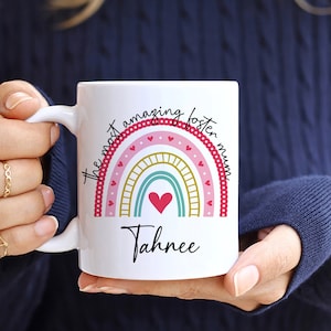 May include: White ceramic mug with a rainbow design and the text "The most amazing foster mum" and the name "Tahnee".