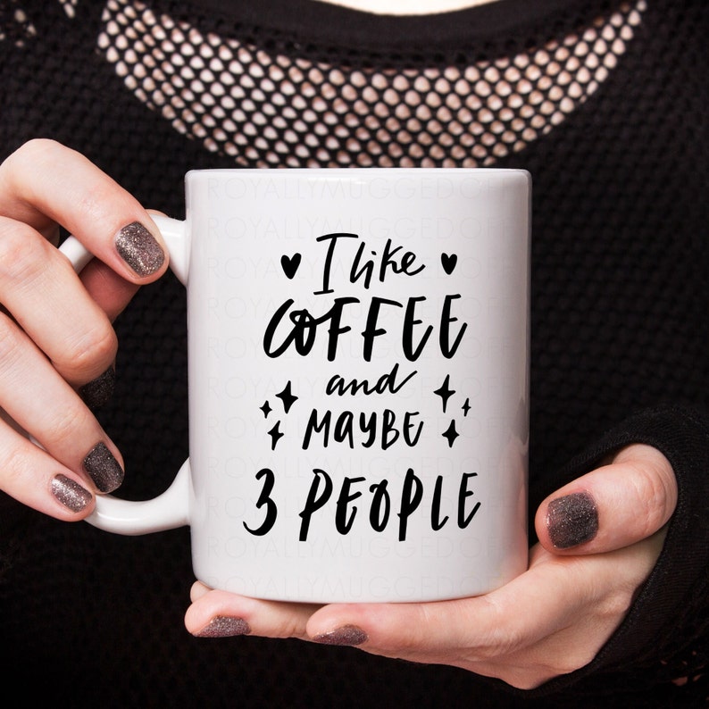 May include: White ceramic coffee mug with black text that reads "I like coffee and maybe 3 people".