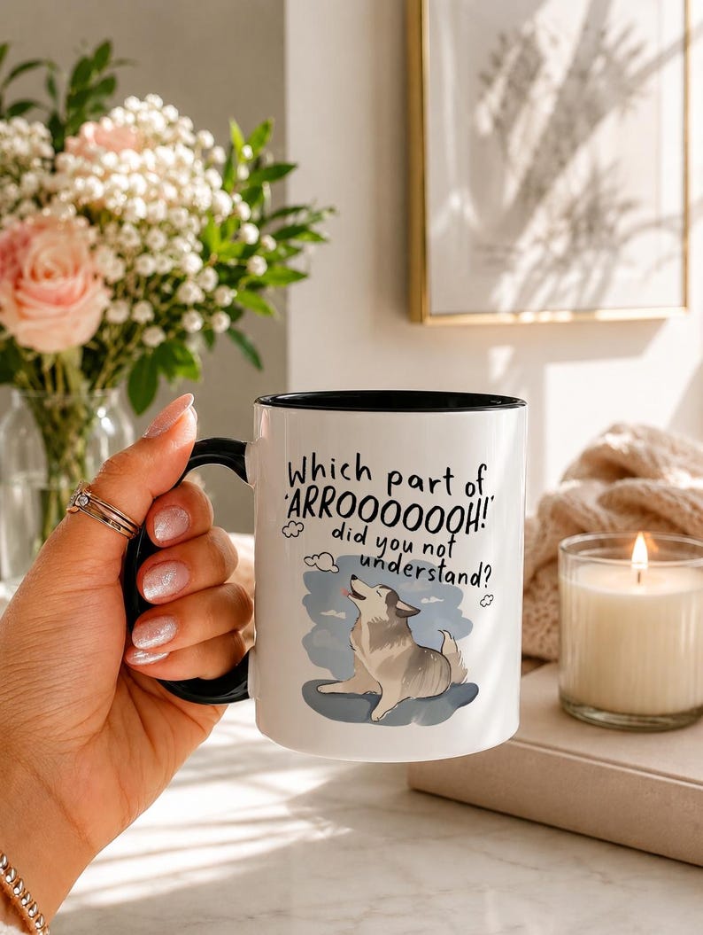 May include: A white ceramic mug with a black handle and interior rim. The mug features a graphic of a howling dog and the text: Which part of ARROOOOOOH! did you not understand? The design includes small cloud illustrations in a blue sky.