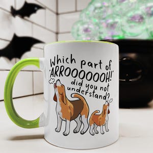 a ceramic mug featuring the phrase 'which part of 'arrooooo!' did you not understand? surrounding an illustration of two beagles howling.