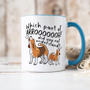a ceramic mug featuring the phrase 'which part of 'arrooooo!' did you not understand? surrounding an illustration of two beagles howling.