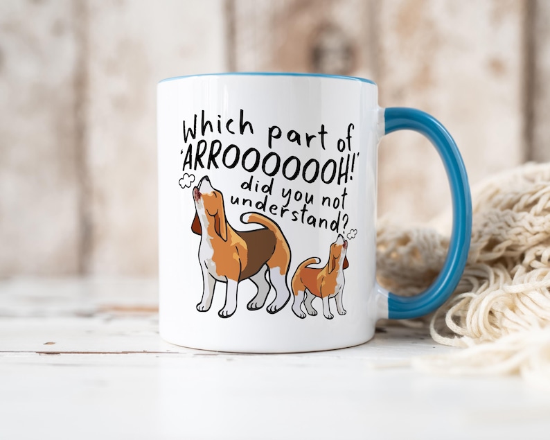 a ceramic mug featuring the phrase 'which part of 'arrooooo!' did you not understand? surrounding an illustration of two beagles howling.