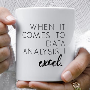 May include: White coffee mug with black text that reads "When it comes to data analysis I excel."