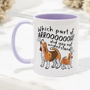a ceramic mug featuring the phrase 'which part of 'arrooooo!' did you not understand? surrounding an illustration of two beagles howling.