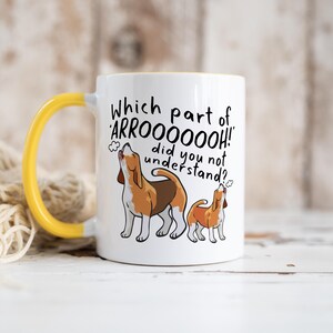 a ceramic mug featuring the phrase 'which part of 'arrooooo!' did you not understand? surrounding an illustration of two beagles howling.