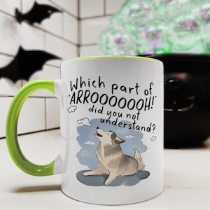 May include: A white ceramic mug with a bright lime green handle and interior rim. The front features a graphic of a howling husky dog with the black text: Which part of ARROOOOOOH! did you not understand? The design includes small cloud icons.