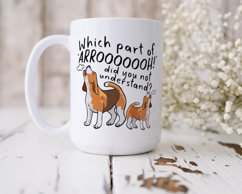a ceramic mug featuring the phrase 'which part of 'arrooooo!' did you not understand? surrounding an illustration of two beagles howling.