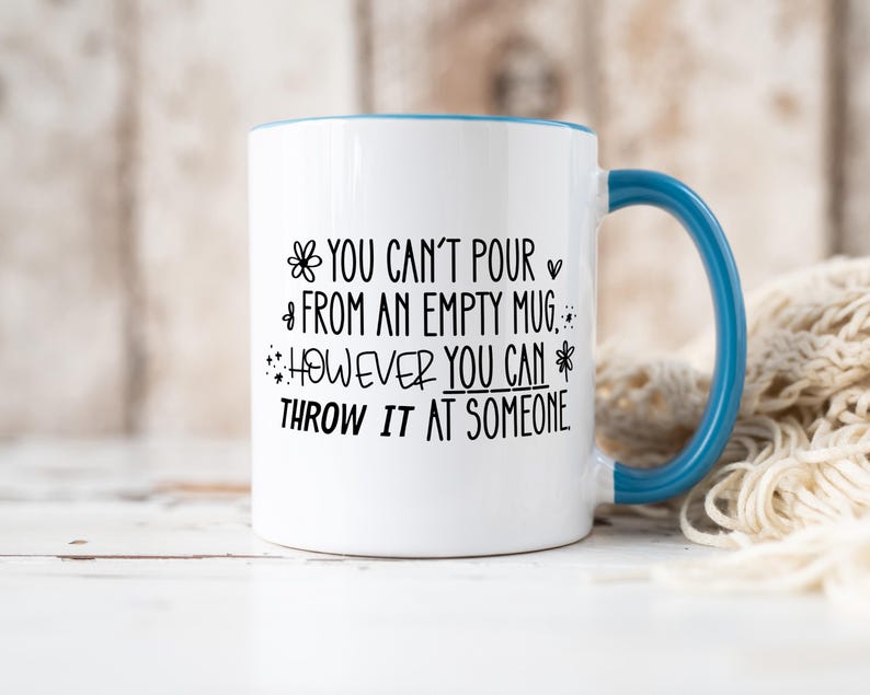 May include: White ceramic mug with a blue handle and rim. The mug features black text that reads "YOU CAN'T POUR FROM AN EMPTY MUG. HOWEVER YOU CAN THROW IT AT SOMEONE."