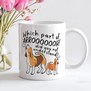 a ceramic mug featuring the phrase 'which part of 'arrooooo!' did you not understand? surrounding an illustration of two beagles howling.