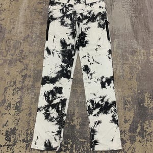 May include: A set of three ceramic mugs with a speckled, matte finish. The mugs are in shades of cream, light gray, and dark gray. Each mug has a simple, minimalist design, perfect for coffee or tea.